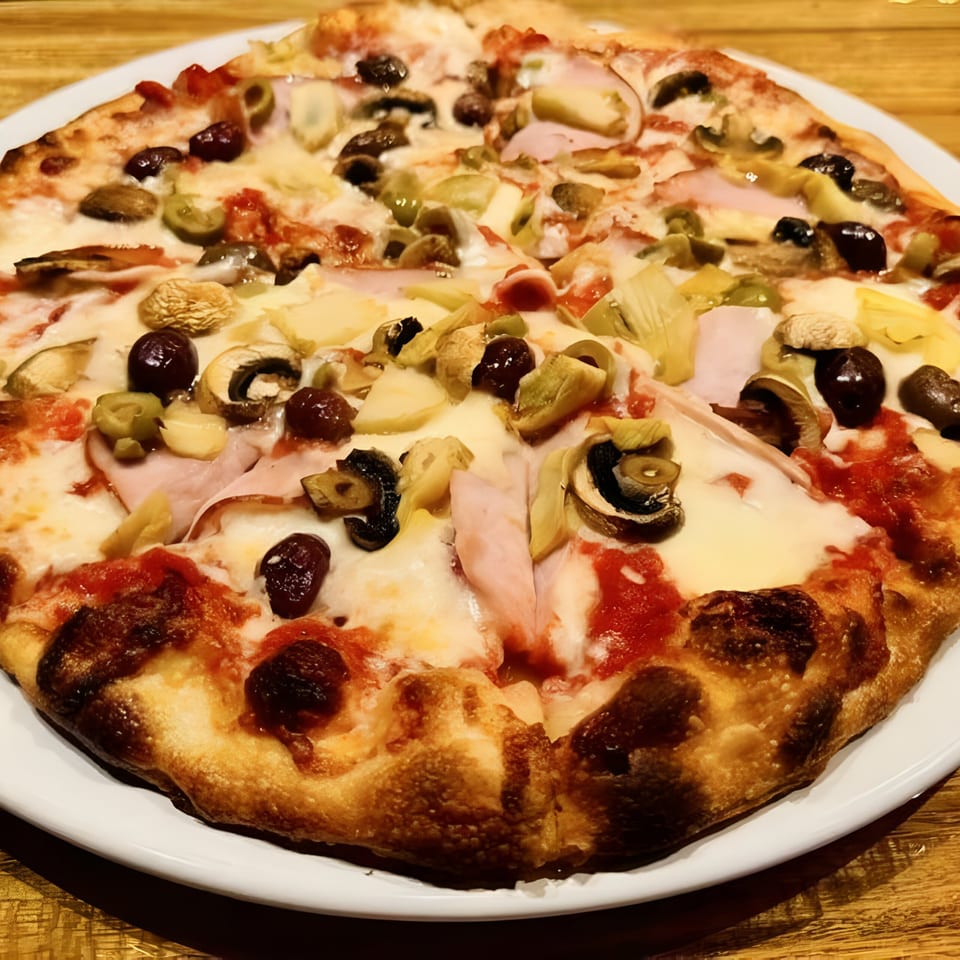 Cafe Napolina's Italian pizza with ham, mushrooms, olives, and artichoke hearts on a white plate.